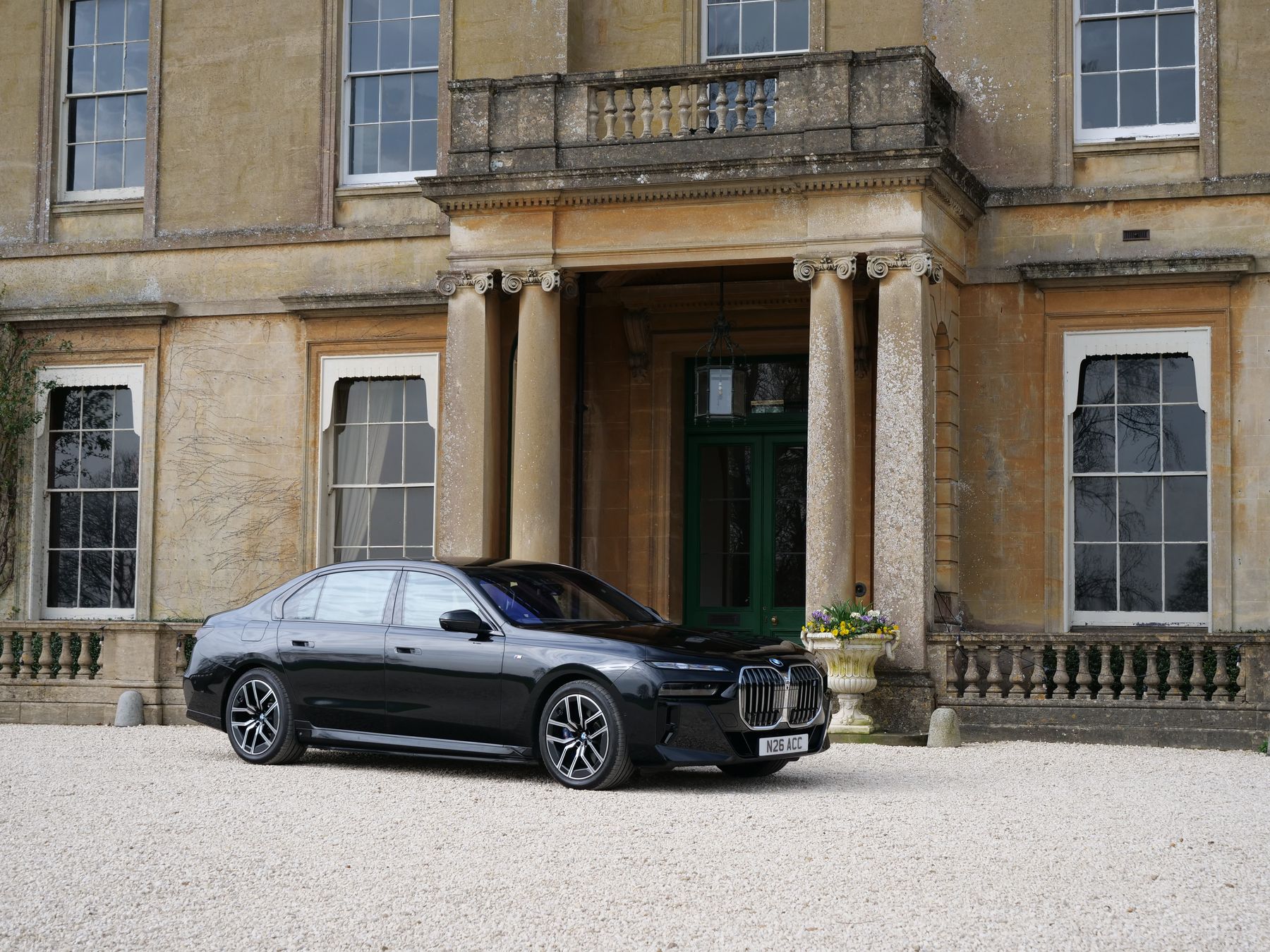 Black BMW i7 outside the columned portico of a Georgian house
