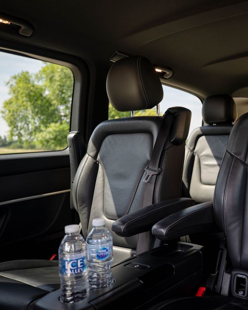 People carrier cabin with individual leather seats and bottled water