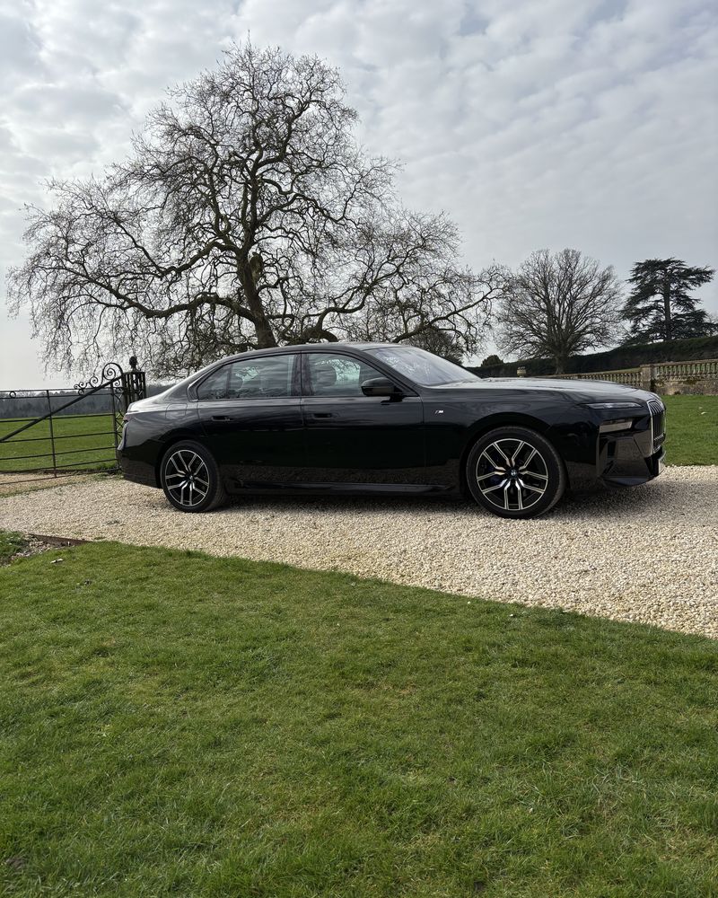 Chauffeur car on a tree-lined gravel drive