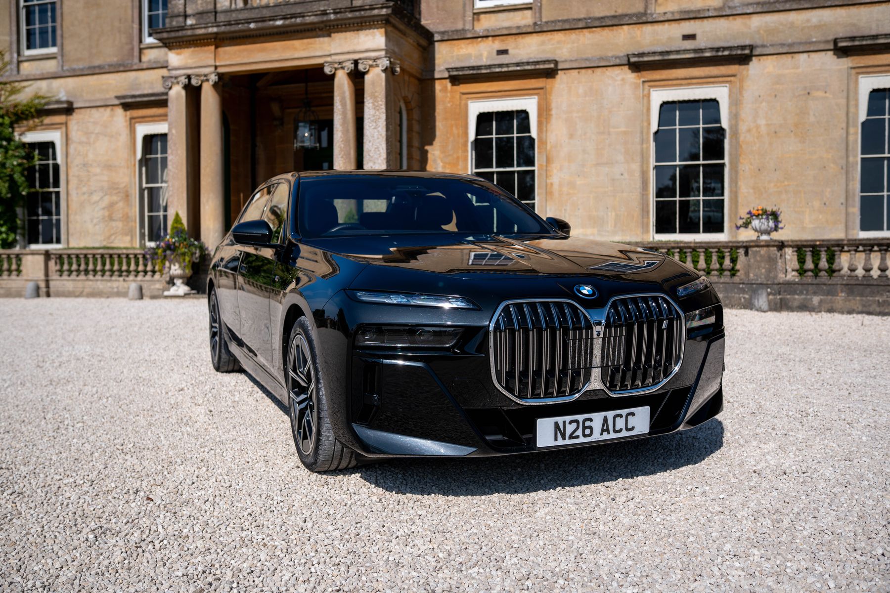 Black BMW i7 facing the camera in front of a Georgian house