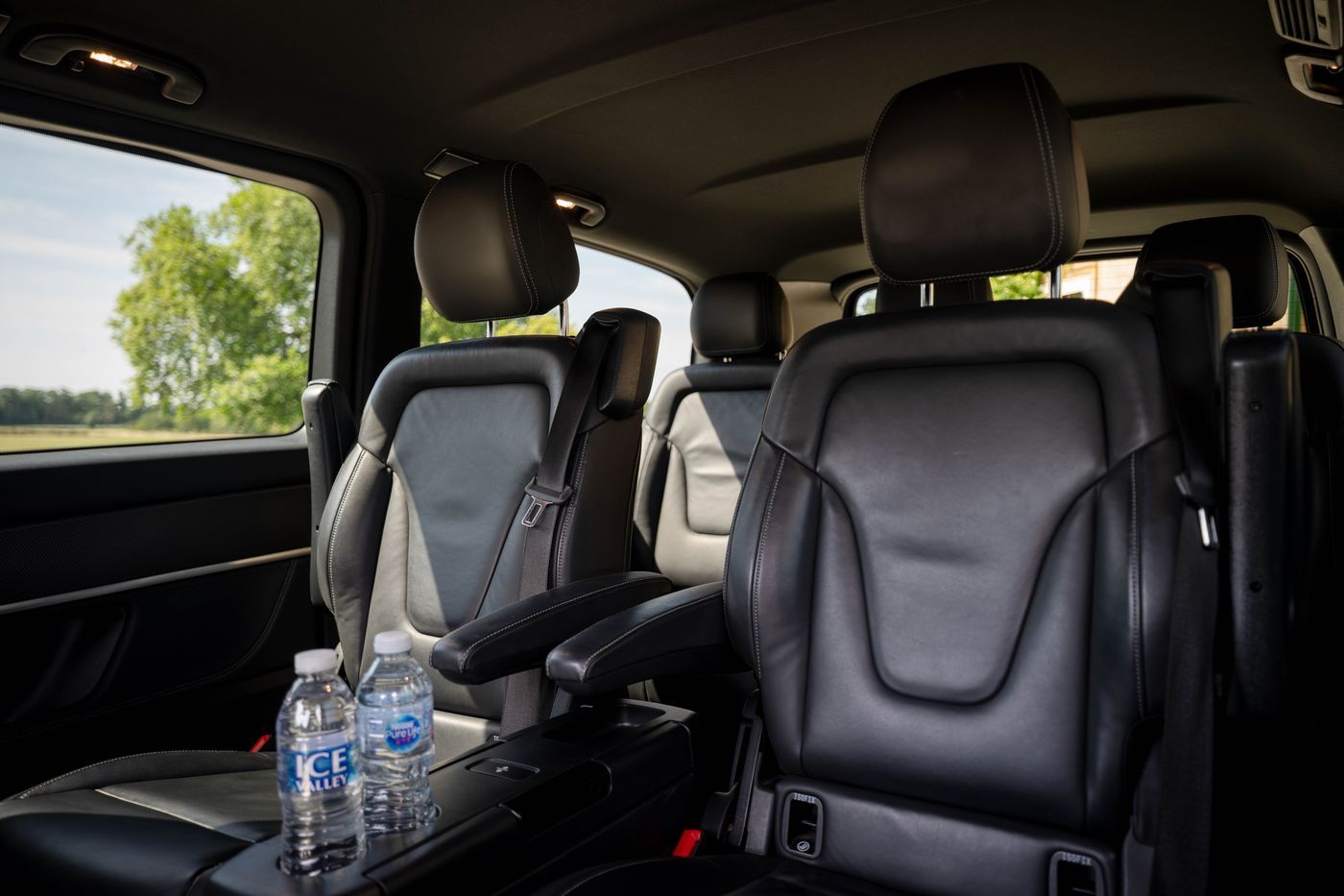 Individual leather seats in a Mercedes V-Class, with bottled water
